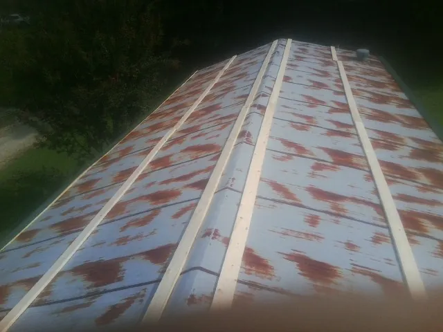 Rusted metal roof panels with new wood purlins before replacement — Storm Damage Roof Repair in Eliot by Roofing Brothers
